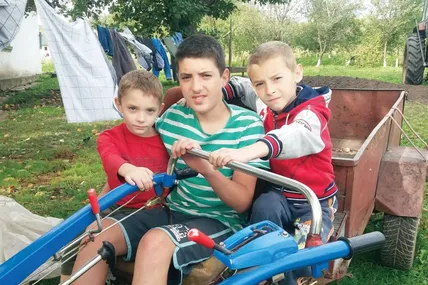 Троє синів сімейства Кайд – Михайлик, Віктор, Андрійко – прийшли допомагати татові при ремонті техніки. А тим часом четвертий син, Максим, у кухні фарширував щуку... Фото автора