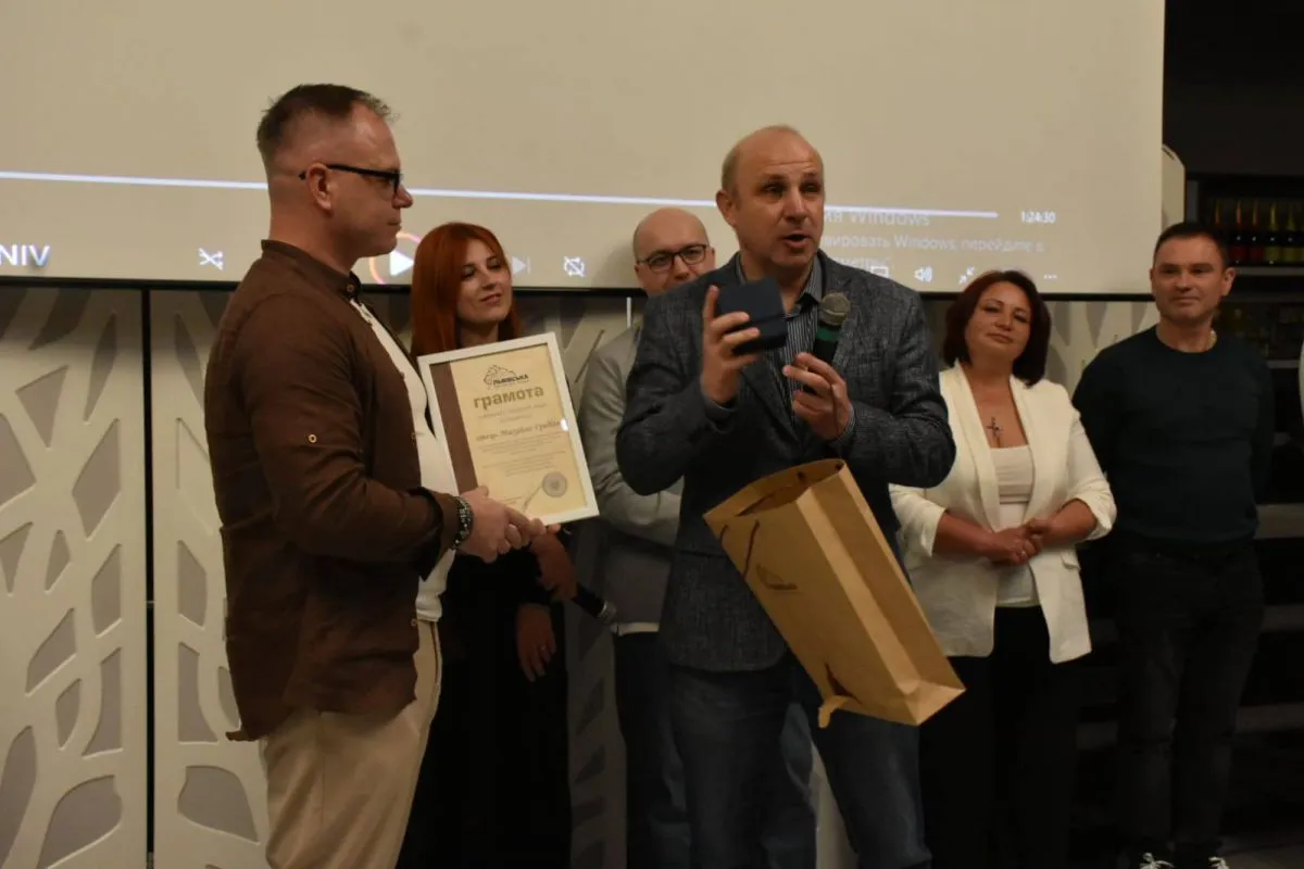 Депутат ЛОР Святослав Шеремета нагороджує о. Михайла Греділя (ліворуч) грамотою.